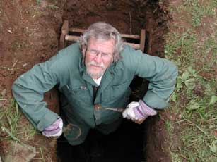 Glen Kealey digging, looking up at the camera